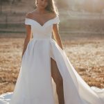 R3602 Allure Romance Crisp, architectural organza softly pleats and tucks along the waist and bodice of this romantic off shoulder gown