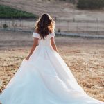 R3602 Allure Romance Crisp, architectural organza softly pleats and tucks along the waist and bodice of this romantic off shoulder gown